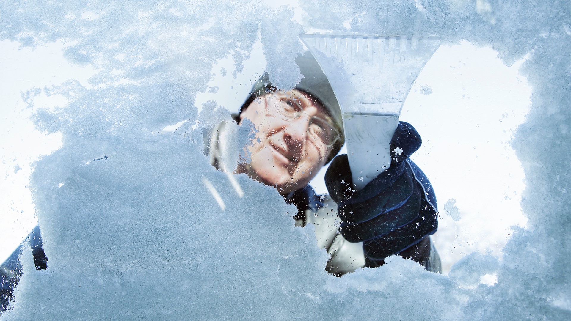 Man skrapar vindrutan på en bil